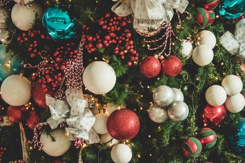 Free Festive Christmas tree with vibrant ornaments and holiday lights. Stock Photo