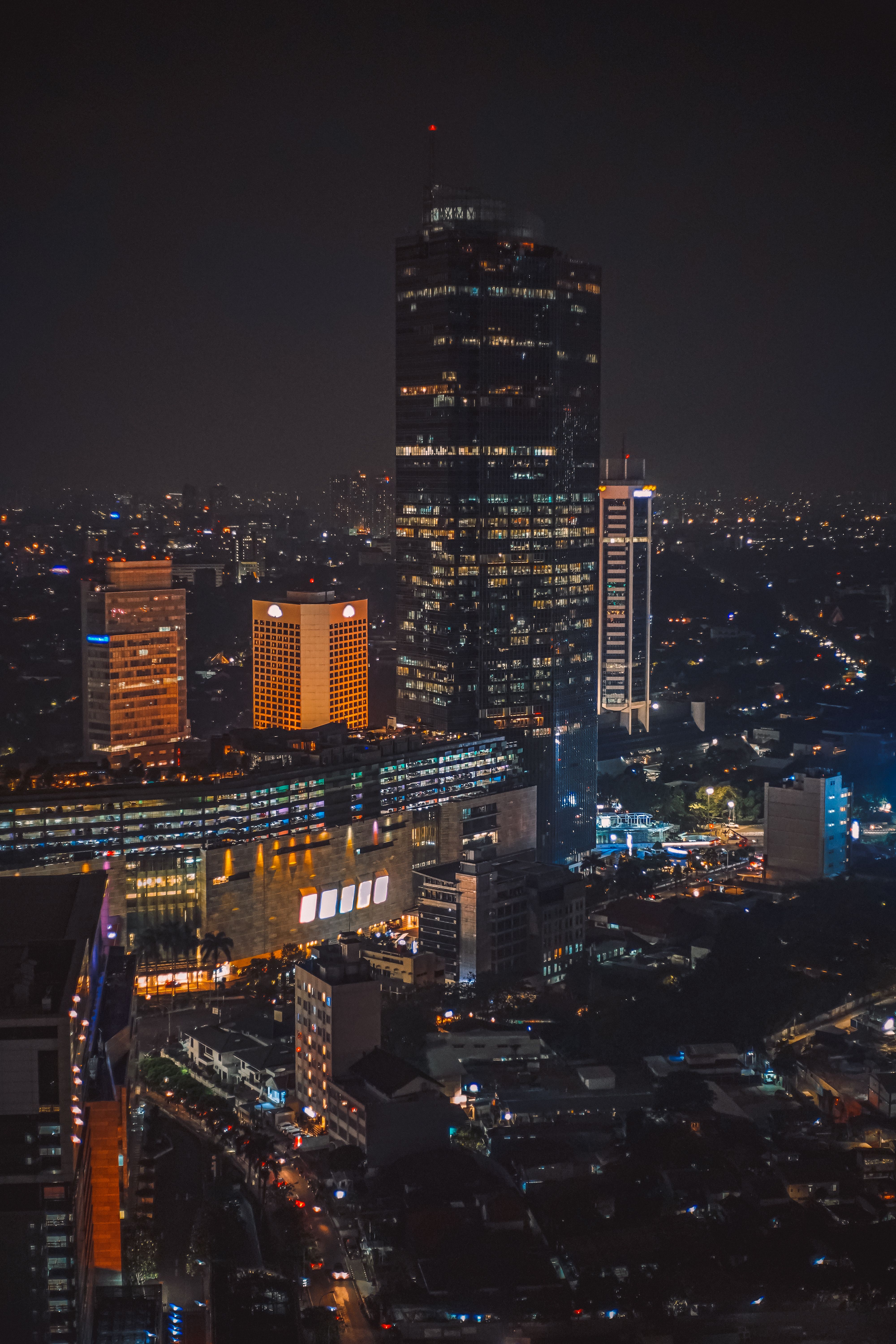 Stunning night view of Jakarta's illuminated skyline with prominent skyscrapers.