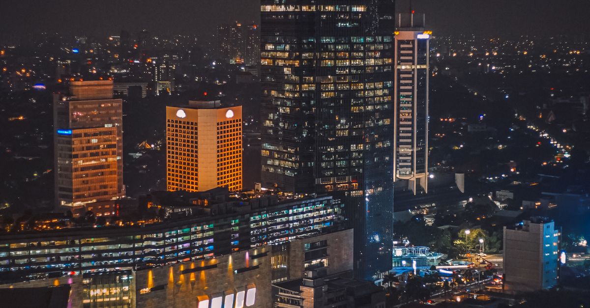 Stunning night view of Jakarta's illuminated skyline with prominent skyscrapers.