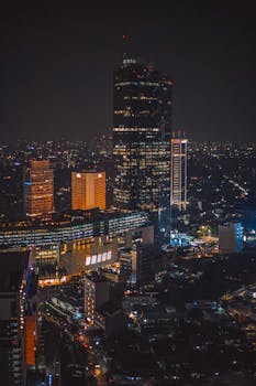 Stunning night view of Jakarta's illuminated skyline with prominent skyscrapers.