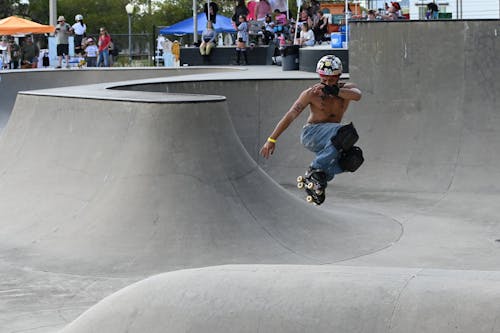 Man Doing Tricks on Roller Skates at an Open Air Skatepark 