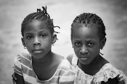 Free Close-up black and white portrait of two young girls with braided hair. Stock Photo
