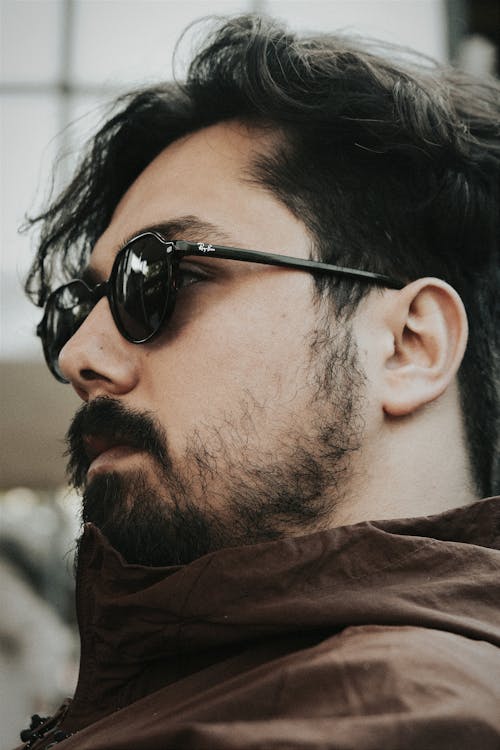 Side View of a Man with a Beard Wearing Sunglasses