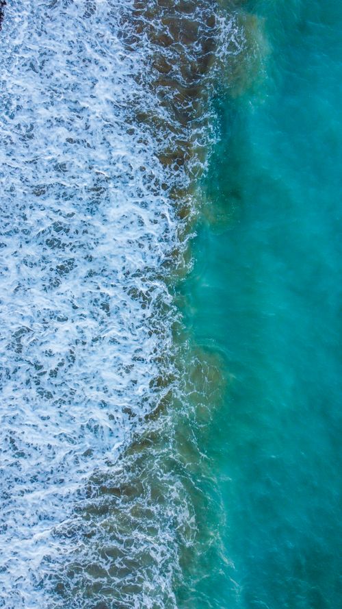 Free Breathtaking aerial view showing turquoise waves crashing onto the shore in Bozyazı, Mersin, Türkiye. Stock Photo