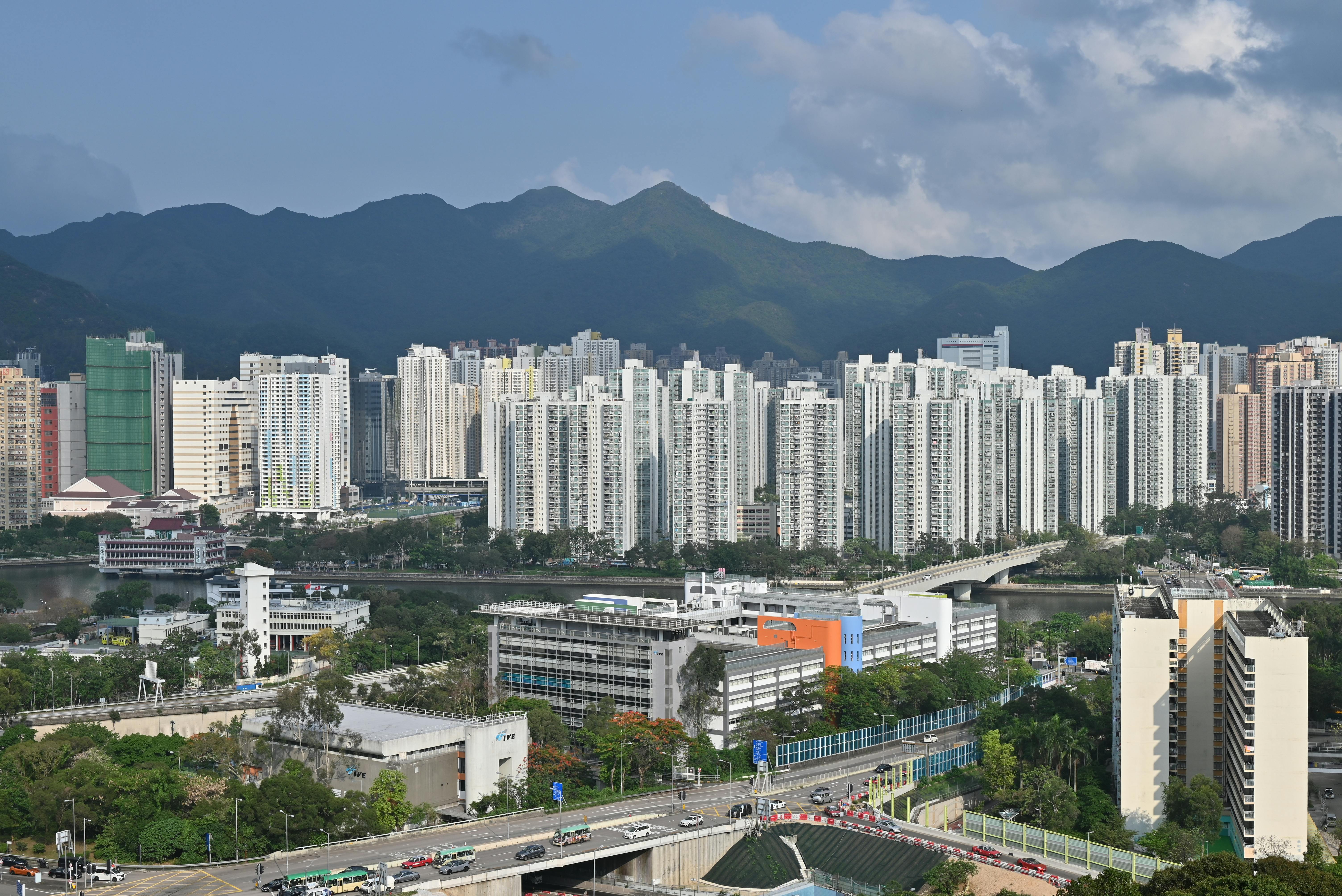 Aerial photograph of Hong Kong's Sha Tin residential district with mountains in the background.