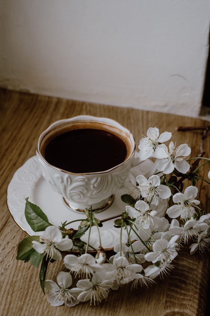 Wedding and event planning workspace with planner, coffee, and greenery