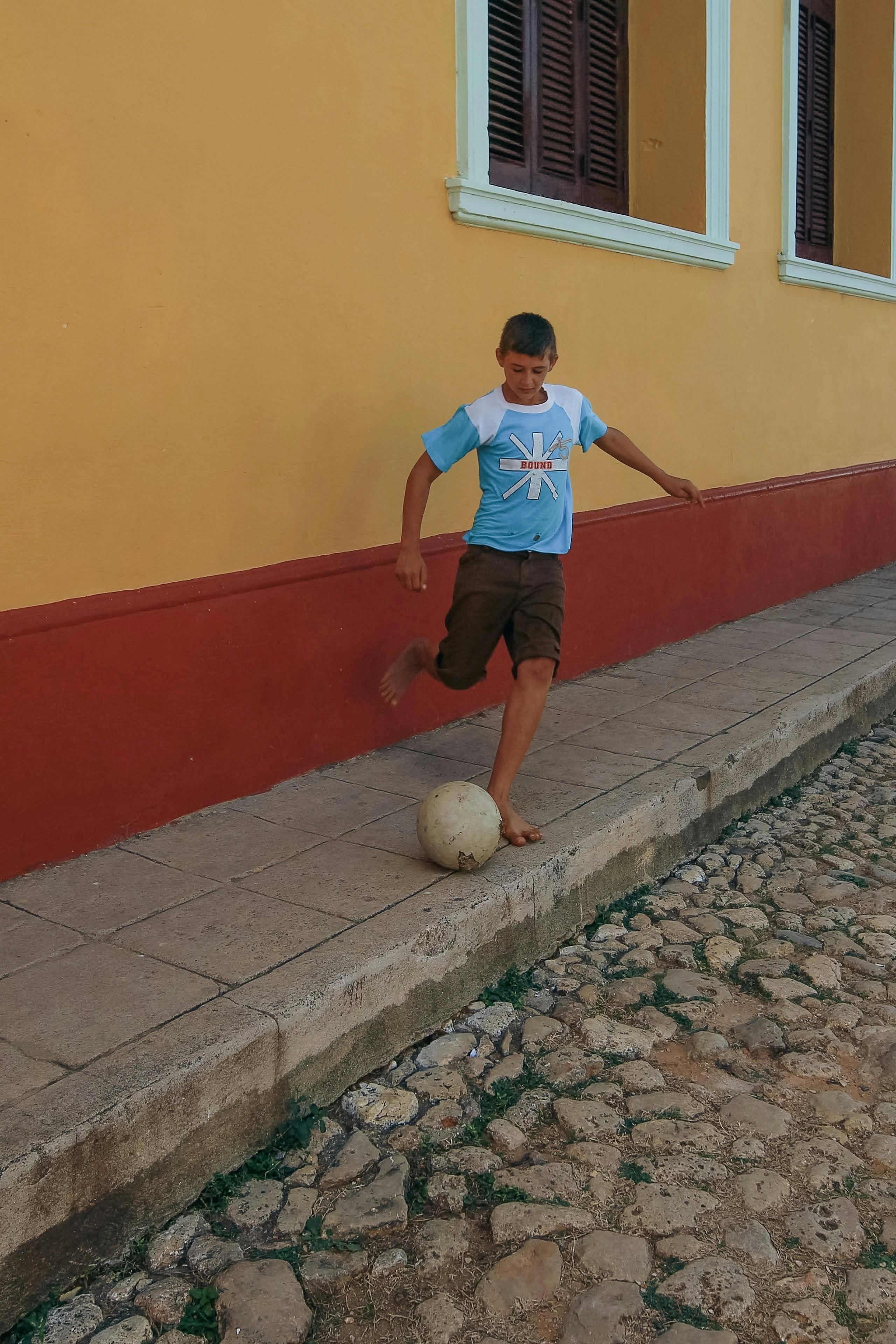 Boy Playing Football Barefoot · Free Stock Photo