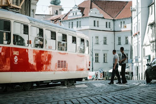 Two Person Standing Beside Train