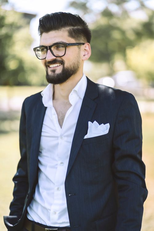 Free A fashionable man with a beard and glasses posing outdoors in Gaziantep, Turkey. Stock Photo