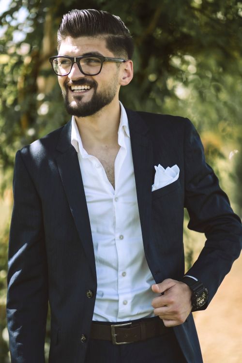 Free A fashionable man in a suit smiling outdoors in Gaziantep, Turkey. Stock Photo