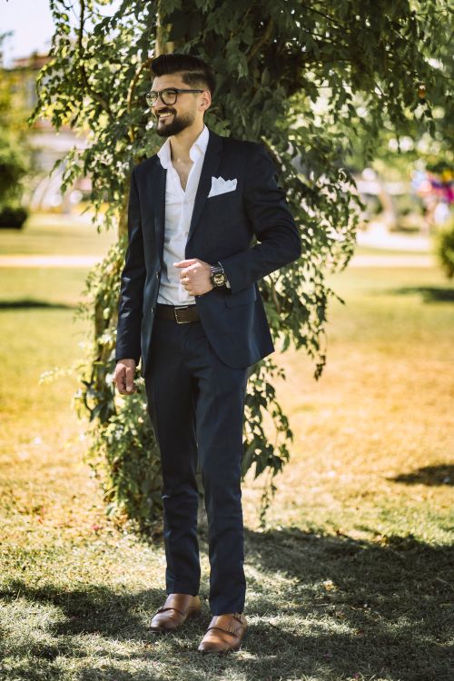 Free A man in a suit standing in a sunny park in Gaziantep, Turkey. Stock Photo