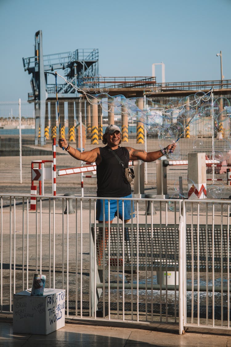 Man With Soap Bubbles On Boardwalk