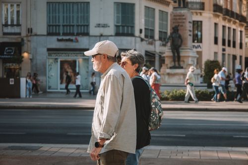 Free Senior couple walking on a sunny day in central Málaga, Spain. Stock Photo