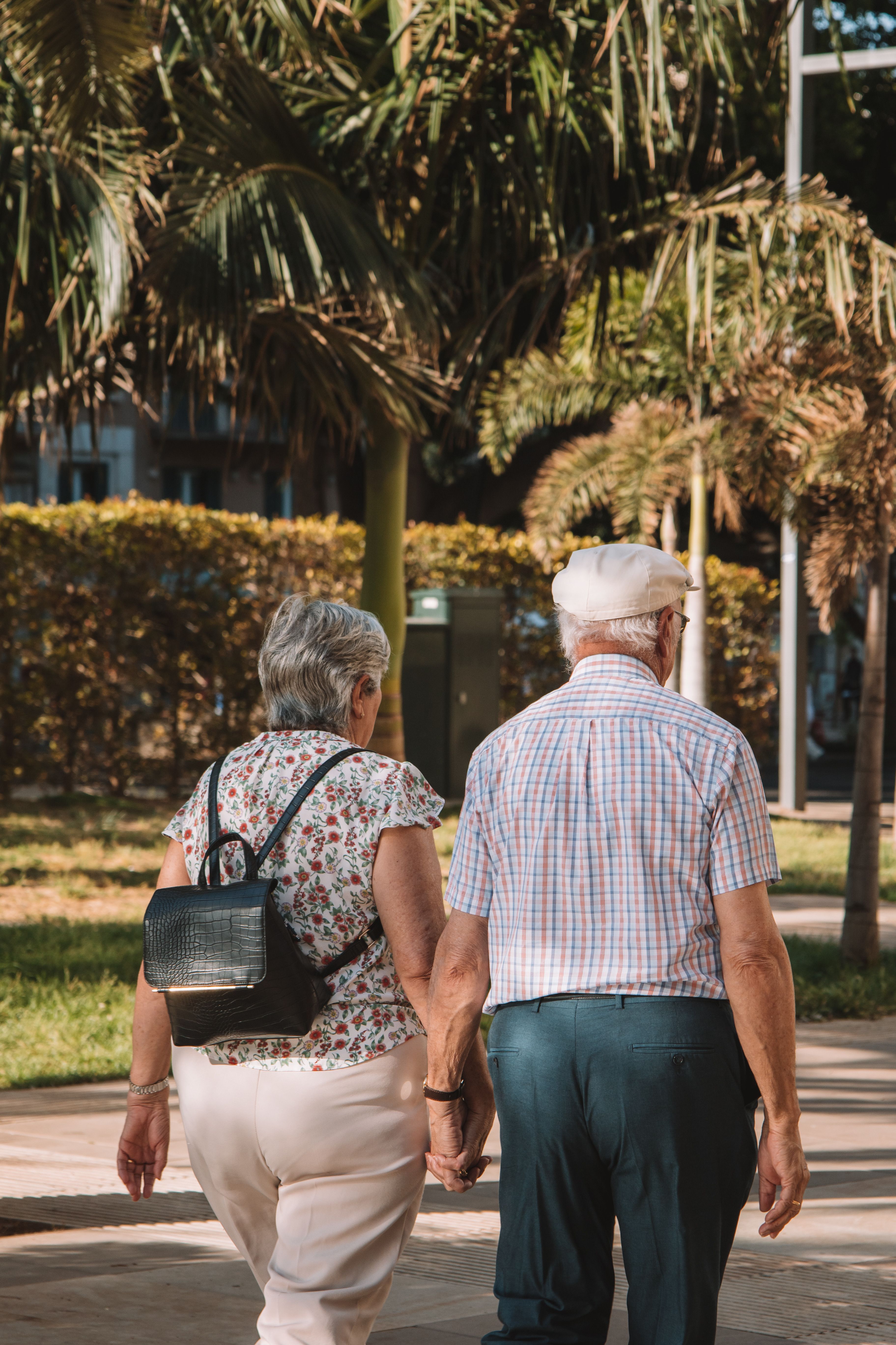 Elderly Couple Walking Together on Pavement · Free Stock Photo