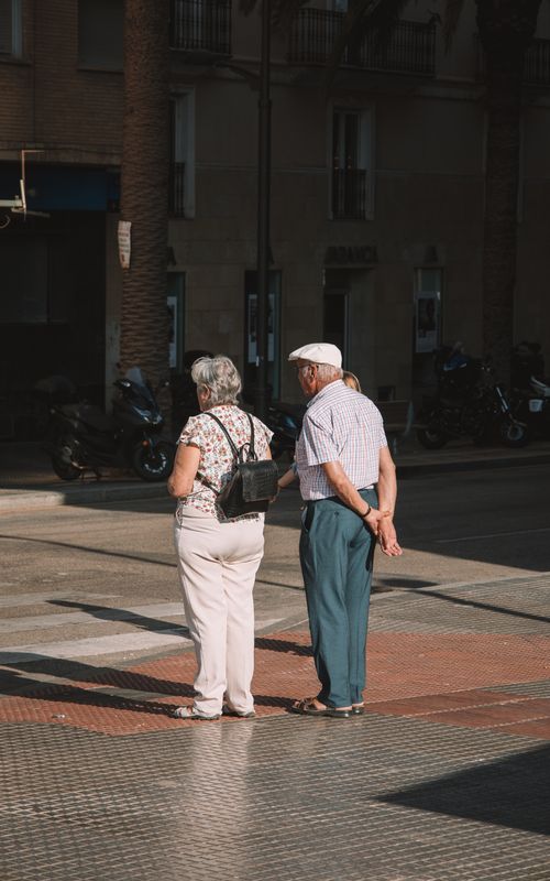 Free An elderly couple enjoying a sunny day on the streets of Málaga, Spain. Stock Photo