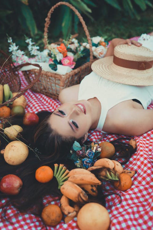 Smiling Woman Lying Down on Picnic Blanket