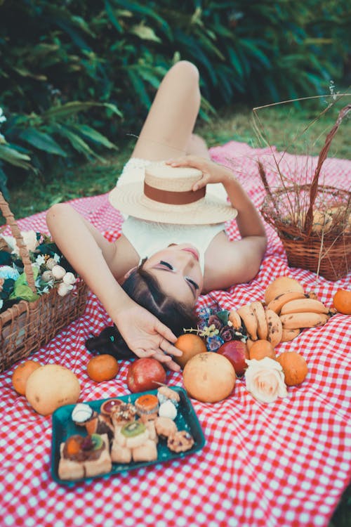 Woman Lying Down and Posing on Picnic Blanket
