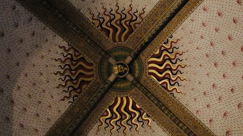 Free Detailed view of an ornate and colorful painted ceiling with geometric and symbolic patterns. Stock Photo
