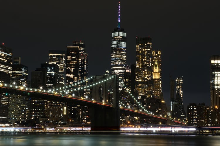 Brooklyn Bridge Against Skyscrapers At Night