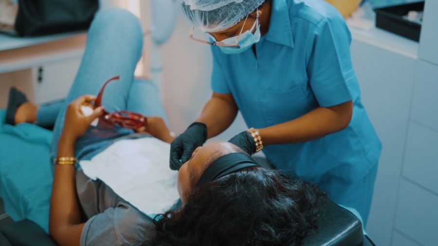 Dental professional consulting with a patient in a clinic