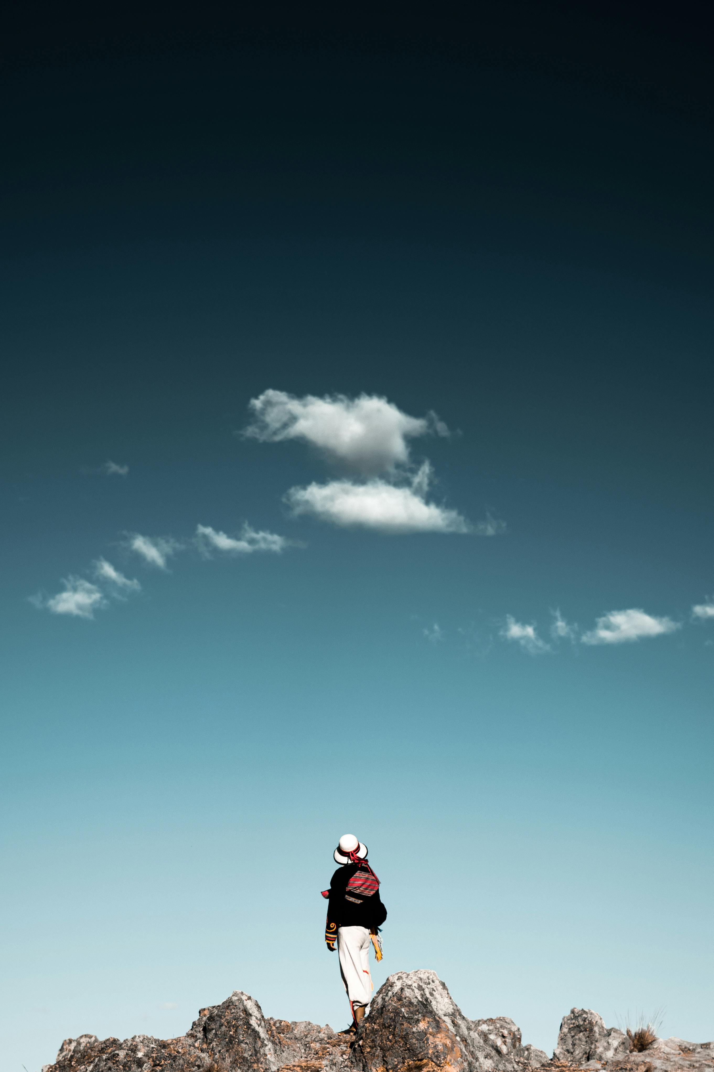 A traveler enjoying a scenic hike in Espinar, Peru with a striking sky and rugged landscape.