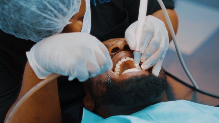 Dentist Working With Patient With Open Mouth