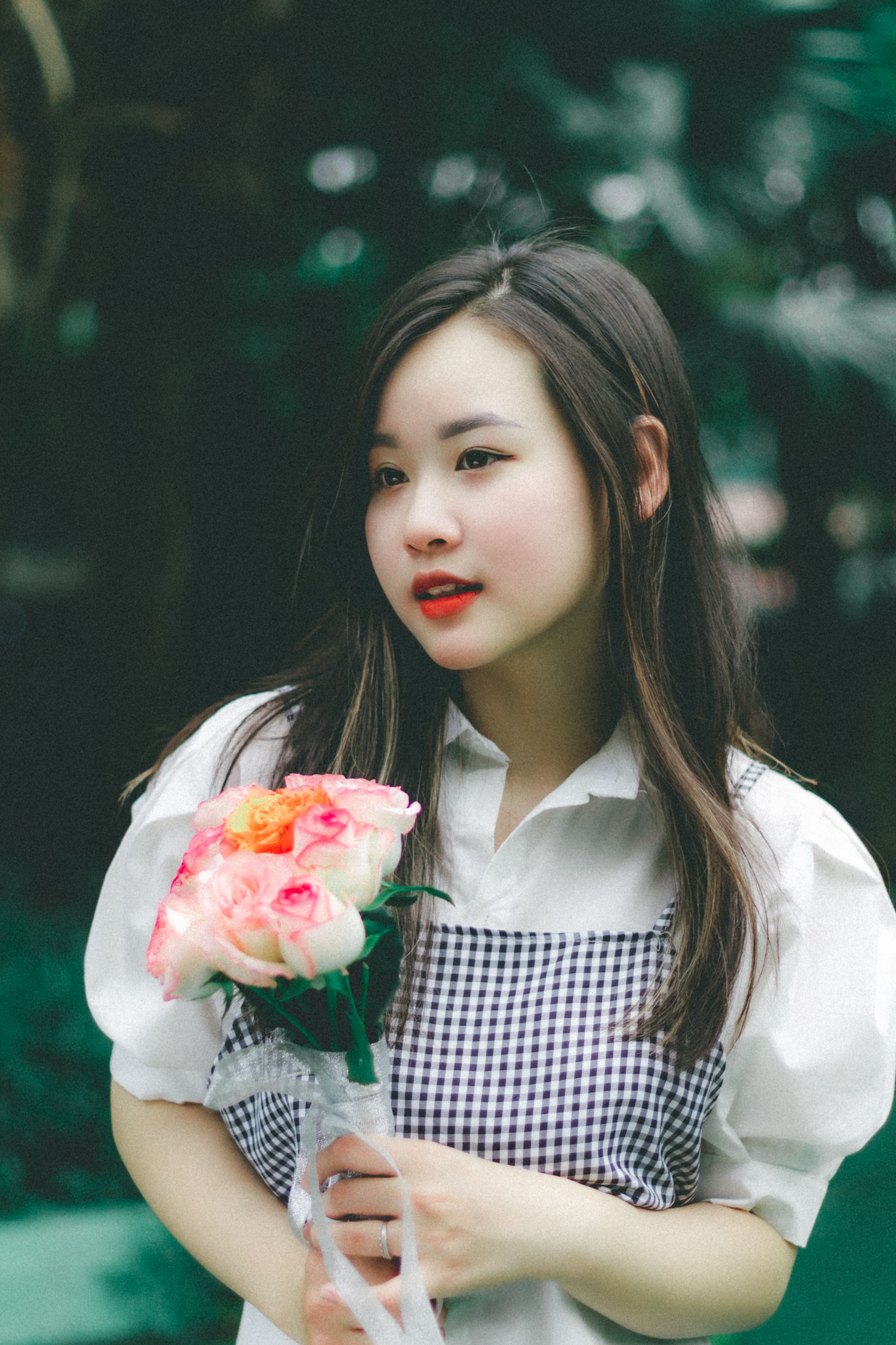 Elegant Woman Posing with Flowers: Captivating Beauty in Nature