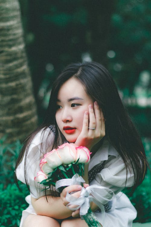 Woman with Black Hair Posing with Roses
