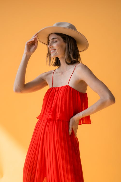 Smiling Woman in Hat and Red Dress