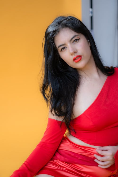 Woman with Black Hair Posing in Red Clothes