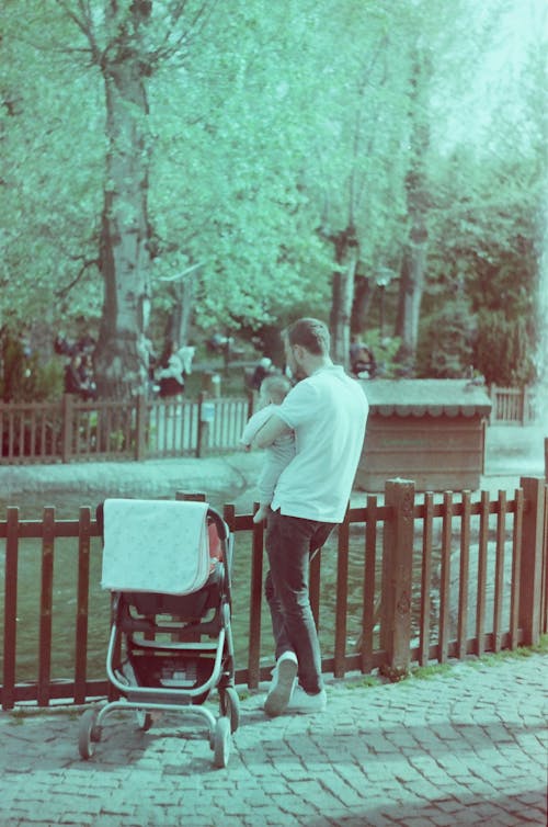 Father Standing with Baby in Park