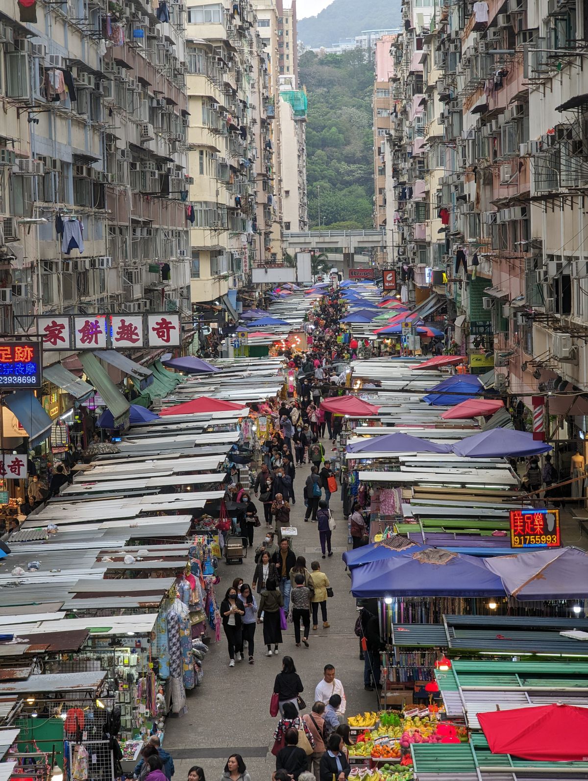 Lively Hong Kong street market in Kowloon with vibrant stalls and local shoppers