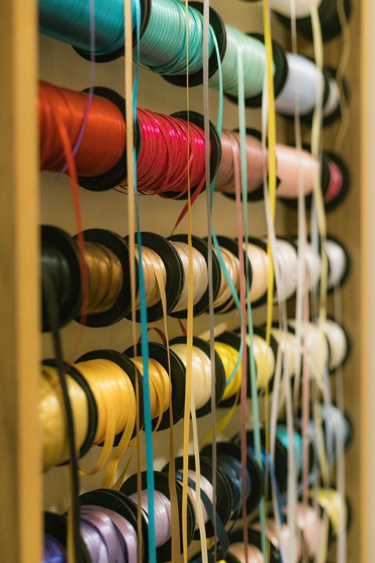 Colourful ribbon spools wound on rods