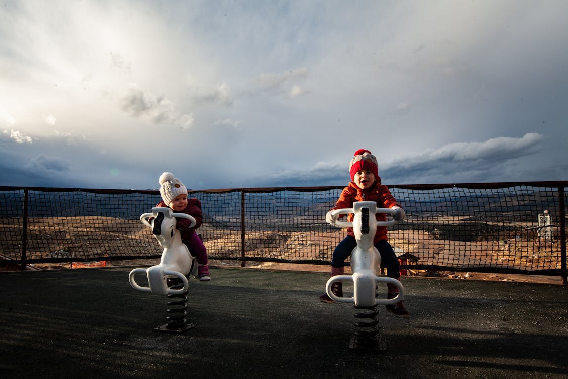  Photo of Toddlers Riding on Spring Horses 