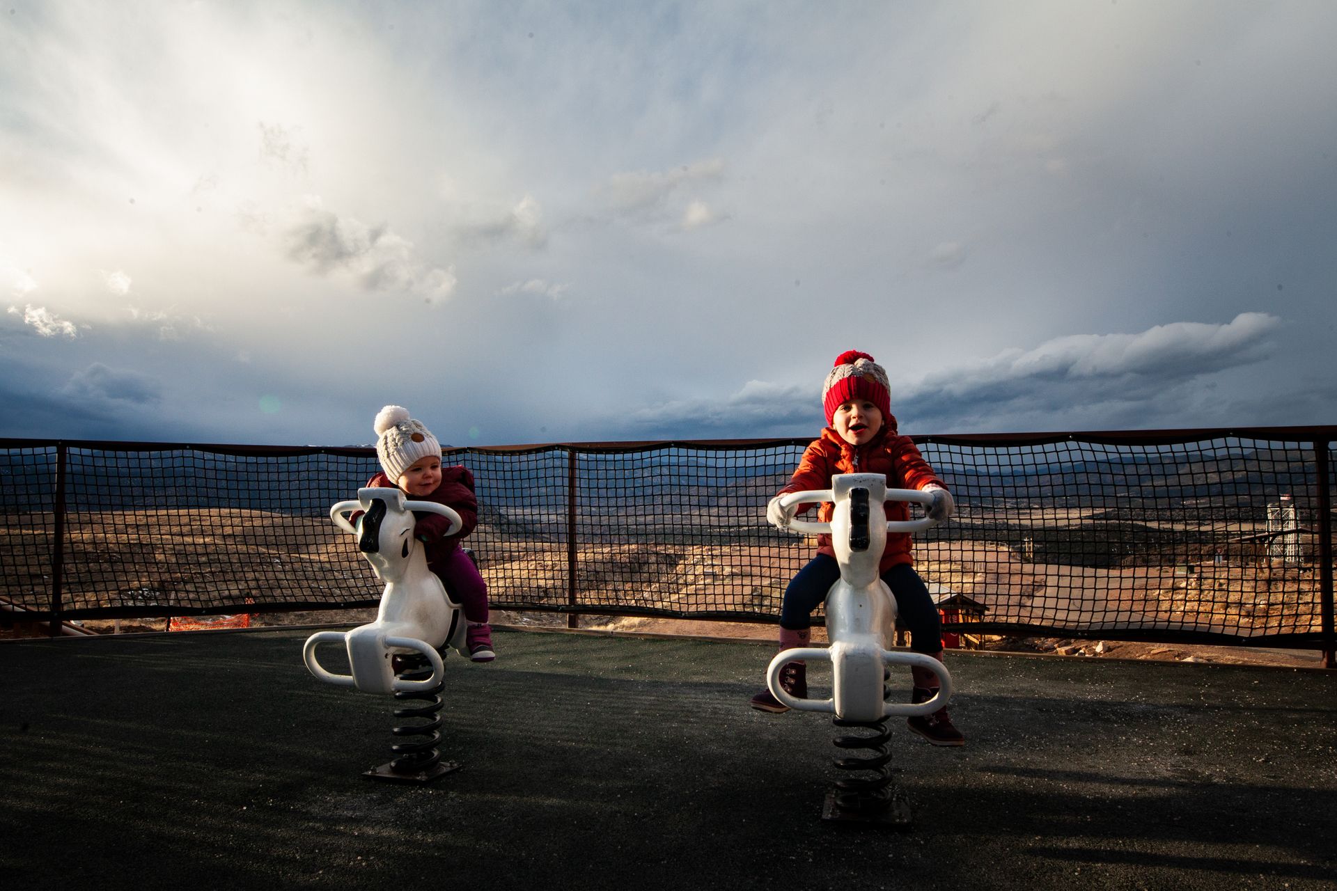 Photo of Toddlers Riding on Spring Horses