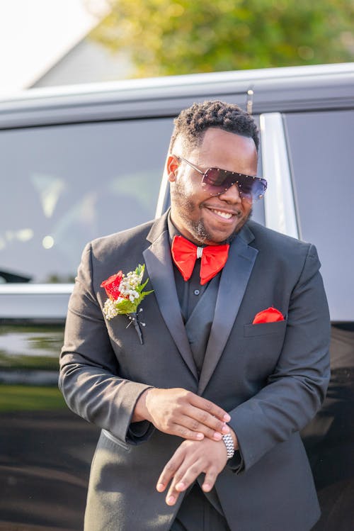 Smiling Man in Wedding Suit Standing by Car