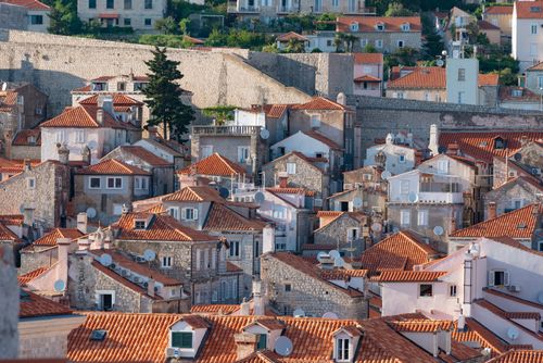 Free Captivating aerial shot of Dubrovnik's iconic terracotta rooftops and ancient stone walls. Stock Photo