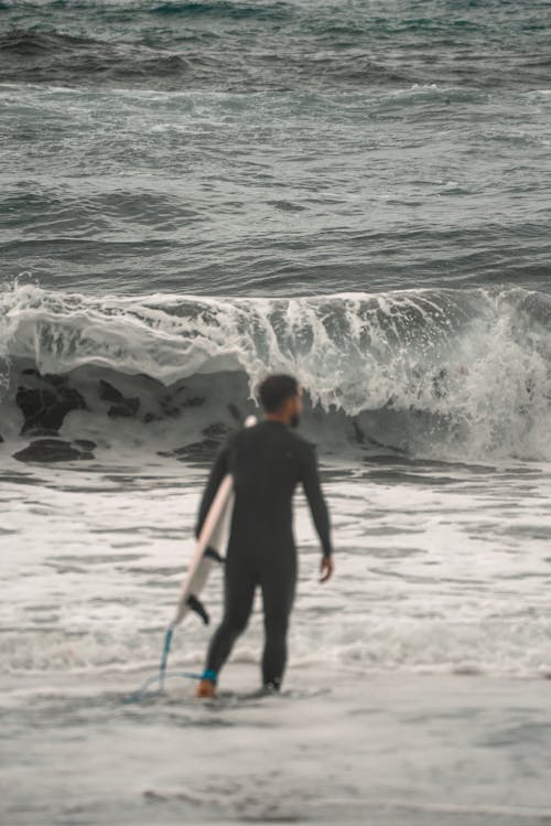 Surfer Walking into Ocean
