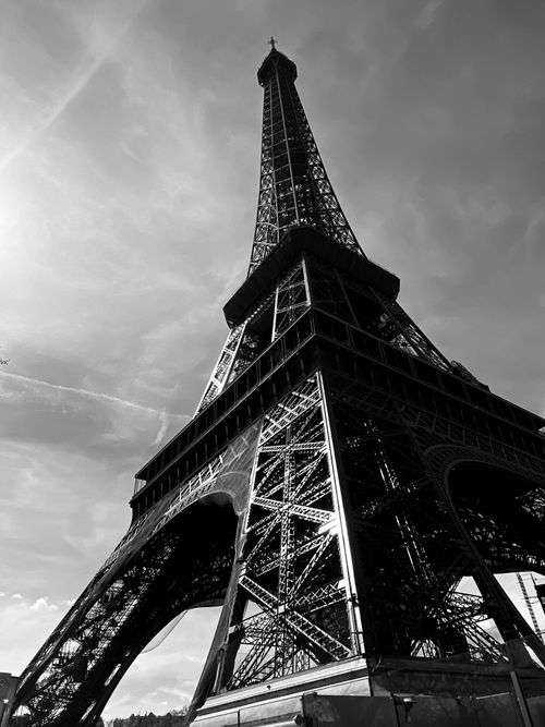 Free Dramatic black and white view of Eiffel Tower in Paris, emphasizing its towering structures. Stock Photo