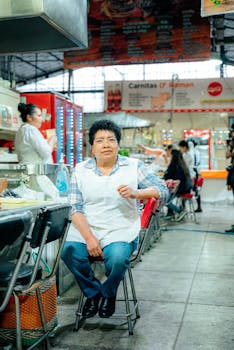 A vendor sits in a bustling market in Ciudad de México, showcasing daily life inside a local setting.
