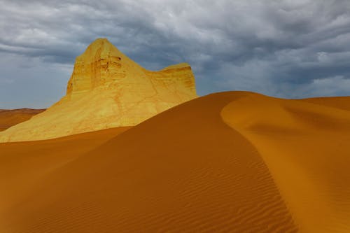 Rock Formation and the Desert Landscape under a Storm Cloud 