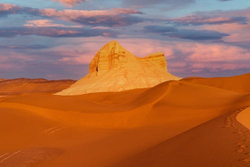 Desert Landscape and Rock Formation under Dramatic Sky 