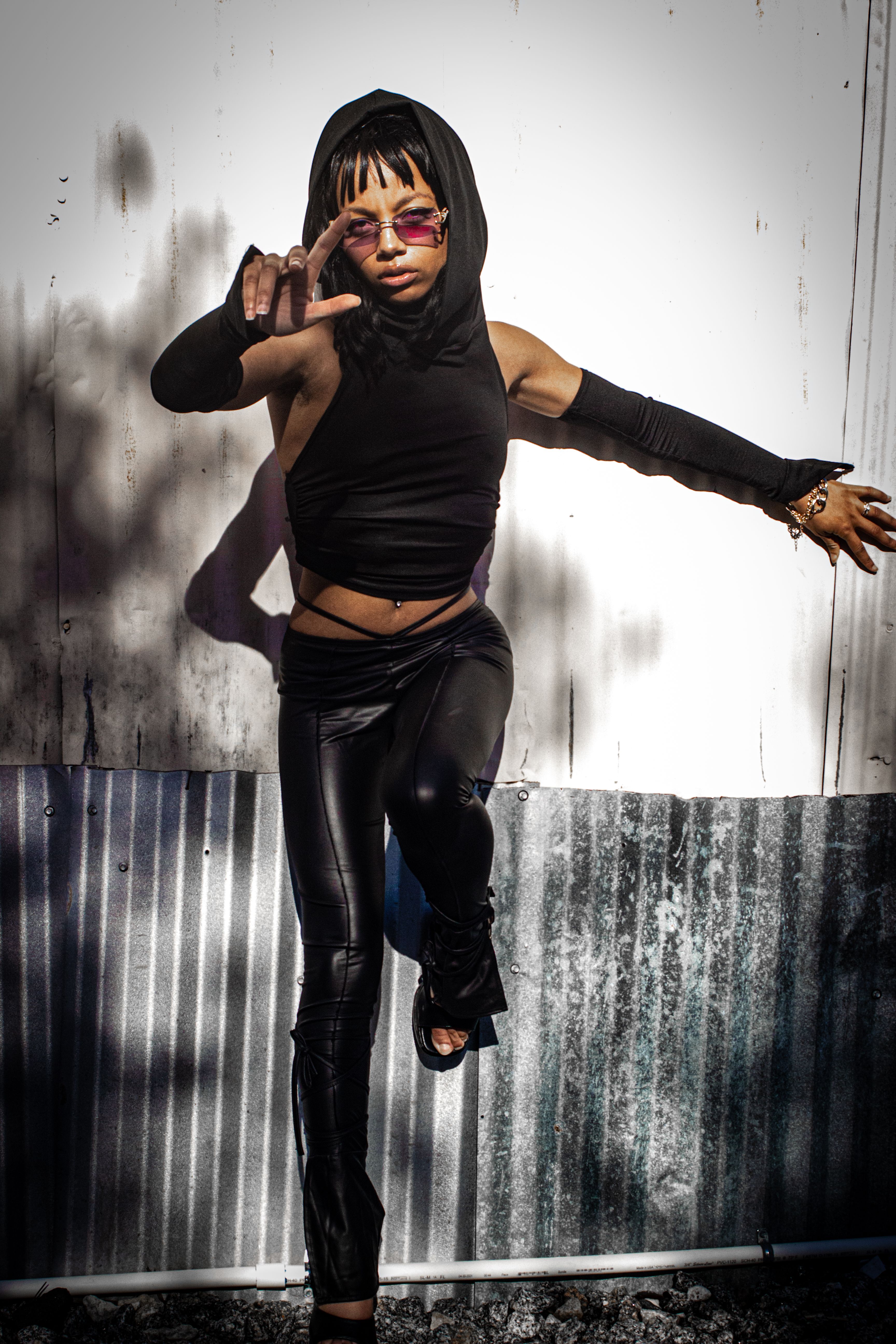 Young Woman in a Black Outfit and Sunglasses Posing Outdoors · Free ...