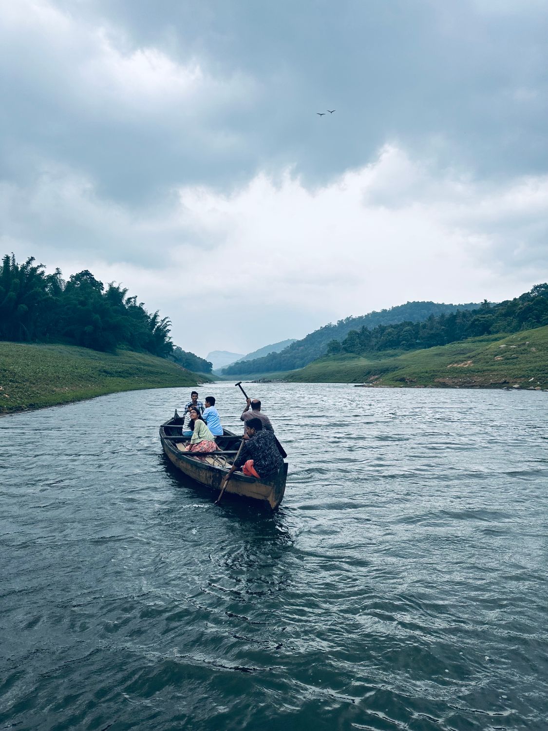 A group of people are riding in a boat on a river · Free Stock Photo