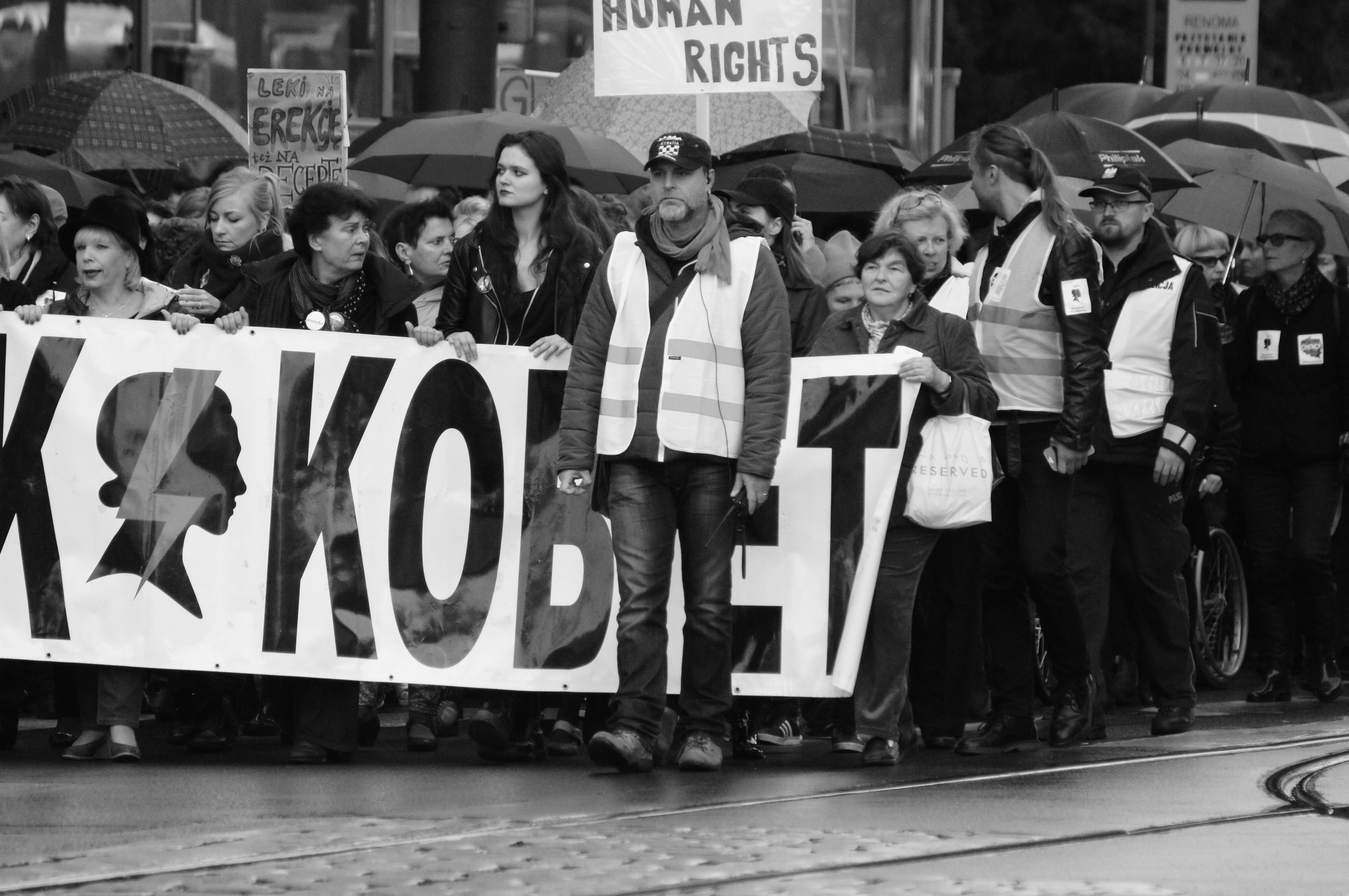 A black and white photo depicting a diverse crowd participating in a human rights protest in Wrocław, Poland.