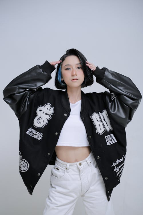 Woman Standing in Oversized Letterman Jacket