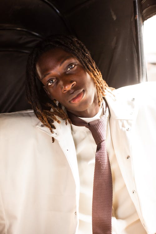 Portrait of a Young Man with Dreadlocks in a Suit