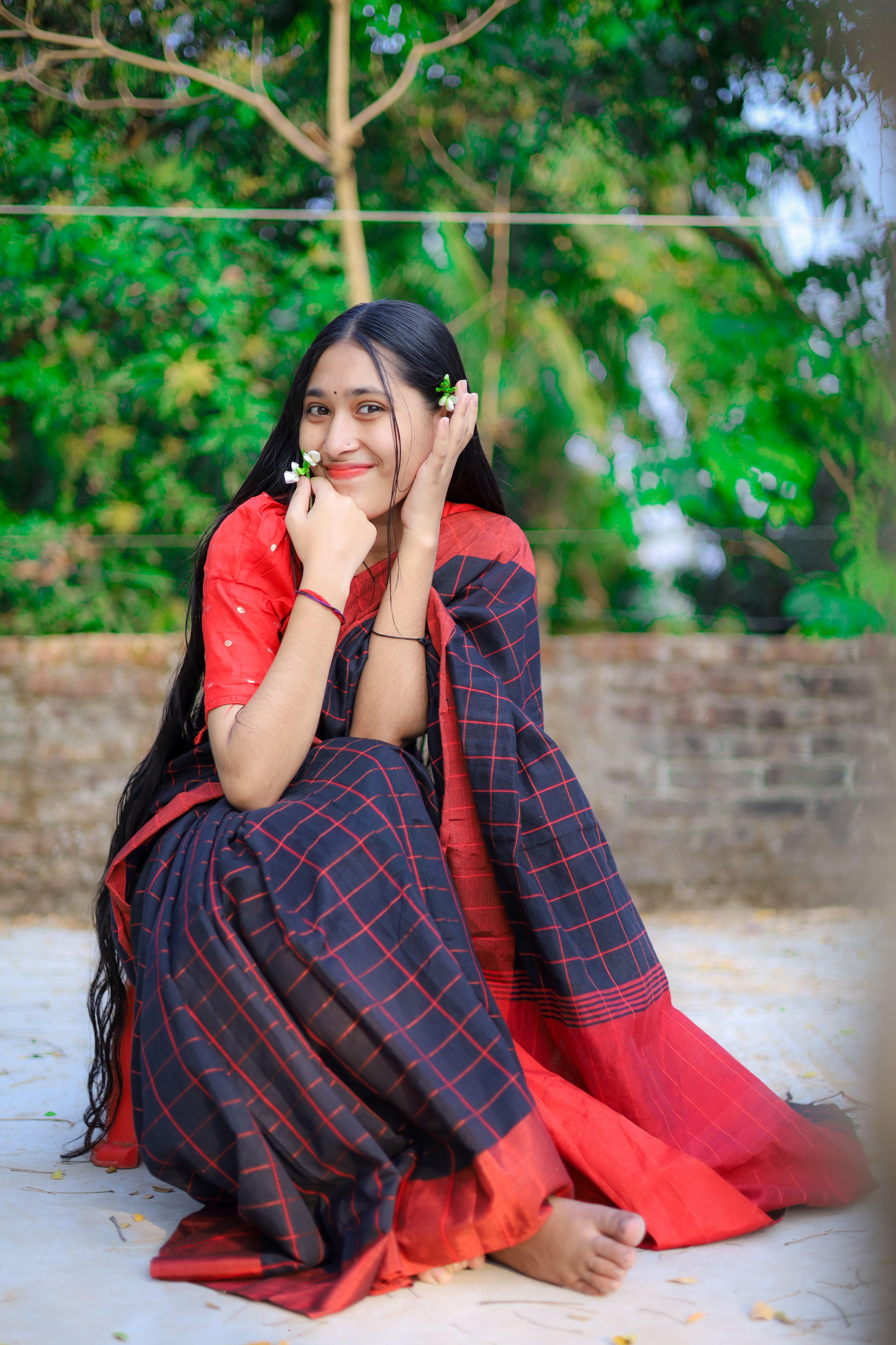 Young Woman in a Traditional Dress Sitting Outdoors · Free Stock Photo