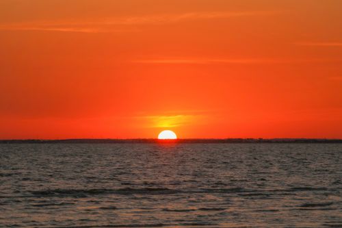 Free Beautiful sunset over Tampa Bay with vibrant red sky and calm sea. Stock Photo