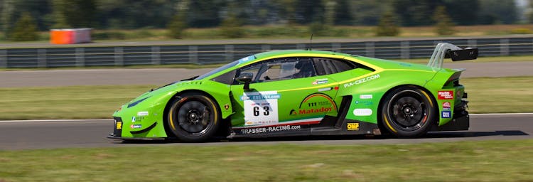 Green Sports Car On Gray Asphalt Road